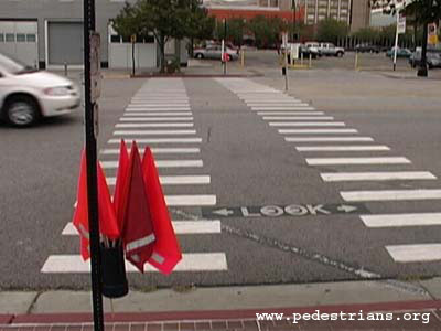 Orange crosswalk flags.