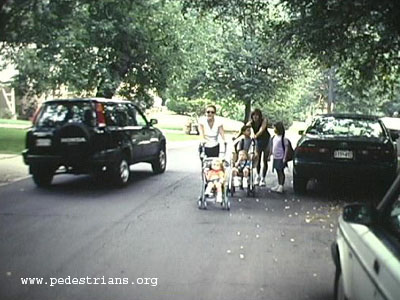 Mothers with strollers in street.