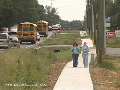 School children on a new sidewalk.