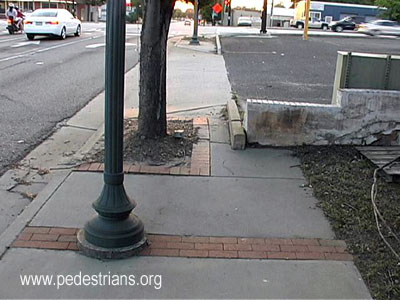 Sidewalk narrows by parking lot, Augusta