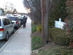 Utility poles behind sidewalk.