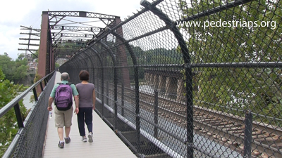 photo - hikers crossing on converted RR bridge.